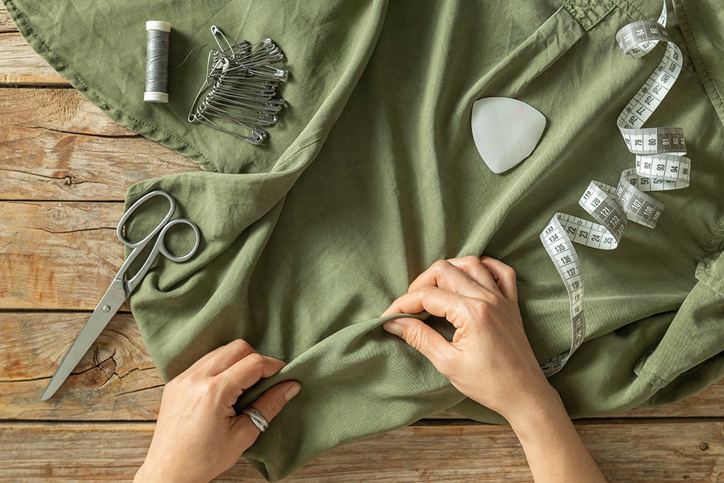 Designers holding a green natural fabric